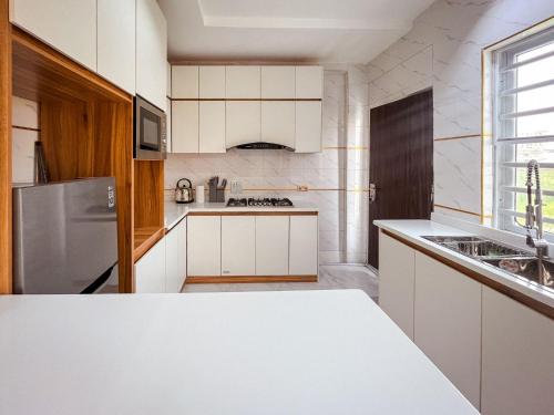 a kitchen with white cabinets and a white counter top at Fully Furnished Luxury 2bedroom Apartment in Lekki