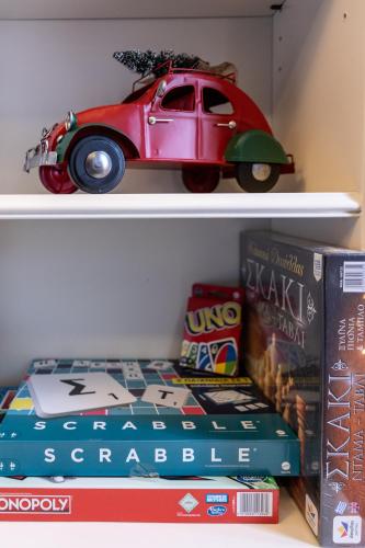 a book shelf with a toy car and books at Rock Dandy La Maison de l'Ours - Nymfaio in Nimfaíon