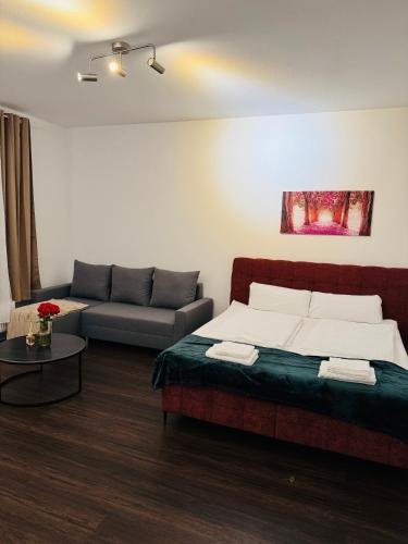 a living room with a bed and a couch at Charmante Auszeit im Harz in Blankenburg