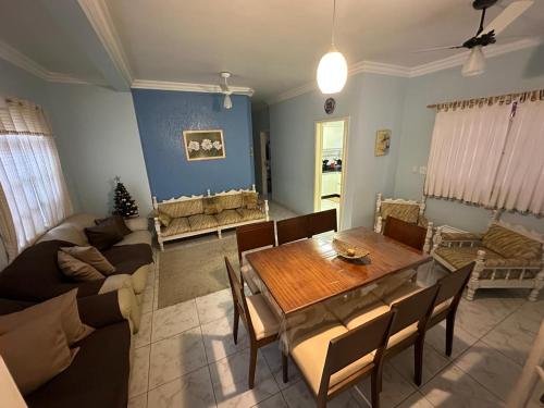 a living room with a table and a couch at Casa no Centro de Bertioga com Piscina in Bertioga