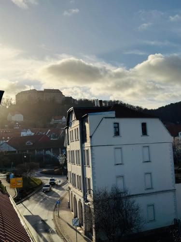 a white building with a view of a city at Magische Auszeit im Harz mit Schlossblick in Blankenburg