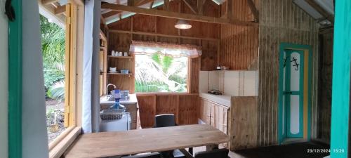a kitchen with a table and a sink in a house at Hotel YELLOW HOME Providencia Isla in Providencia