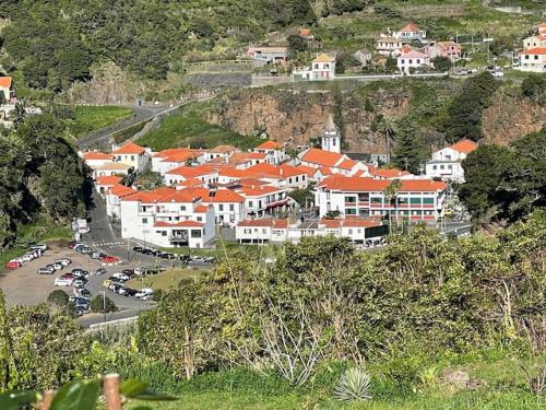a group of buildings with cars parked in a parking lot at CGD São Vicente Apartments in São Vicente