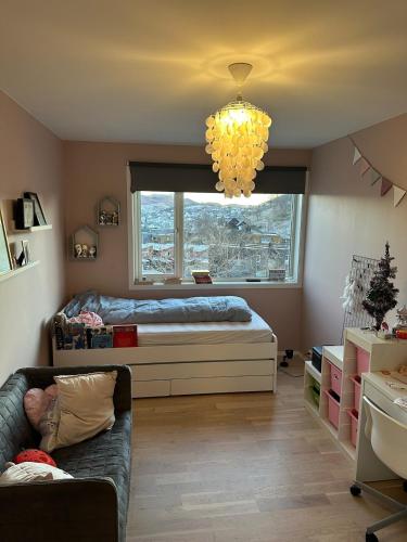 a bedroom with a bed and a window at Family house in Ålgård in Ålgård