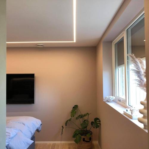 a bedroom with a bed and a window at Family house in Ålgård in Ålgård