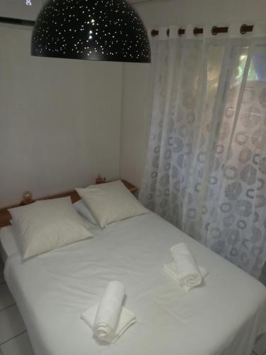 a bedroom with a bed with two paper towels on it at Lagoon Studio Plage in Schœlcher