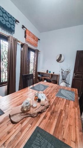 a wooden table in a room with a wooden floor at Casa de Lami in Dalung
