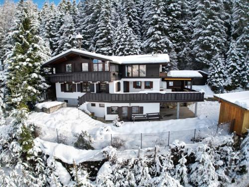 a house in the snow with snow covered trees at Amazing cottage in Tyrol with sauna in Volders