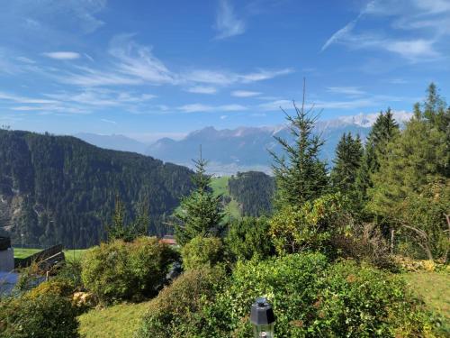 a view of a valley with trees and mountains at Amazing cottage in Tyrol with sauna in Volders