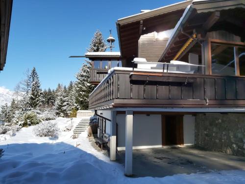 a house in the snow with a balcony at Amazing cottage in Tyrol with sauna in Volders