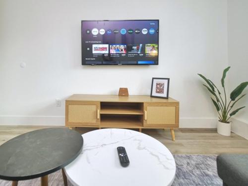 a living room with a tv and a table at Molivu Homes 1BR - New Build, Pet Friendly, W-D in San Jose