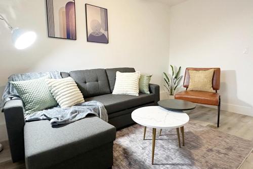 a living room with a couch and a table at Molivu Homes 1BR - New Build, Pet Friendly, W-D in San Jose