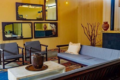 a living room with a blue couch and chairs at Nook Tulum in Tulum