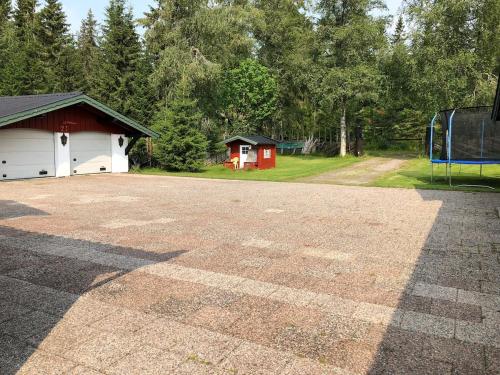 an empty parking lot with a building and a playground at Cozy cabin 1,5 hours from Oslo in Hamar