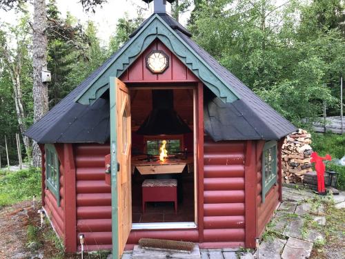 a red shed with a clock on top of it at Cozy cabin 1,5 hours from Oslo in Hamar