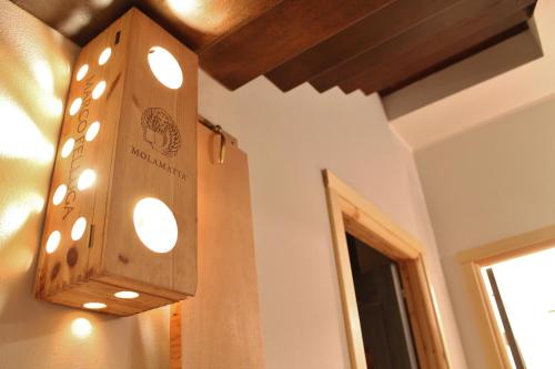 a wooden light fixture hanging from a wall at Rooms Maison 3 Magnoni in Trieste