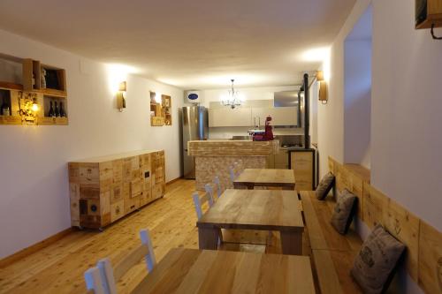 a restaurant with wooden tables and a kitchen with a counter at Rooms Maison 3 Magnoni in Trieste
