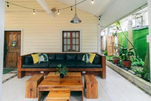 a patio with a couch and a coffee table at Pineapple House in Bocas del Toro