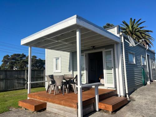 a covered deck on the side of a house at Holiday Home on Iconic Tay St Location 3 bedrooms in Mount Maunganui