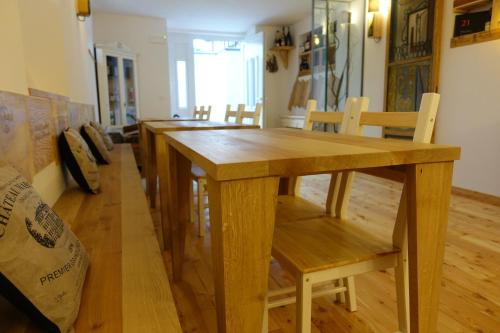 a dining room with a wooden table and chairs at Rooms Maison 3 Magnoni in Trieste