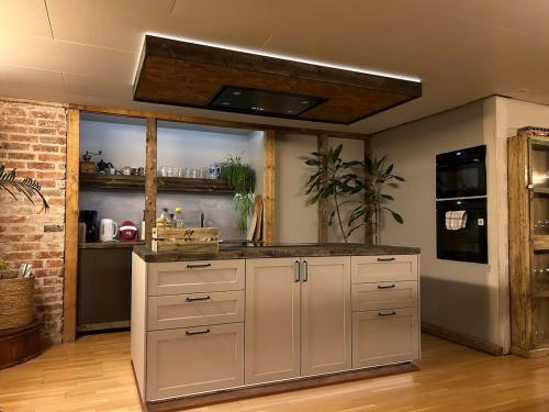 a kitchen with white cabinets and a counter top at Cabin with large outdoor area in Hamar