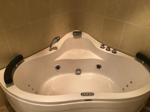 a bath tub with a faucet in a bathroom at Cabin with large outdoor area in Hamar