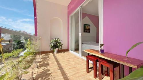 a room with a table and a purple wall at Homestay NAD nguyên căn tại Phan Thiết in Ấp Sung Xuân