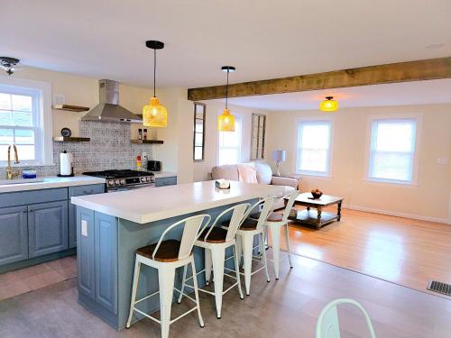 a kitchen and living room with a large island at Cozy Coastal Cottage in New London