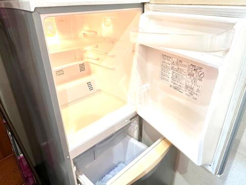 an open refrigerator with its door open at Starry Forest Inn KURIHAI in Oita