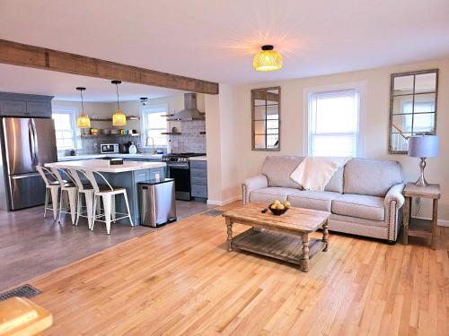 a living room with a couch and a table at Cozy Coastal Cottage in New London