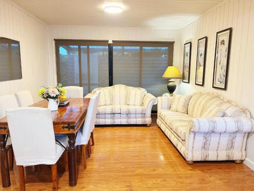 a living room with a table and a couch at home in capelsound in Capel Sound