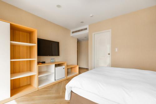 Postel nebo postele na pokoji v ubytování Mu Chen Hotel