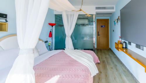 a bedroom with a pink bed with white curtains at 我们的小院-不期而遇 in Zhoushan