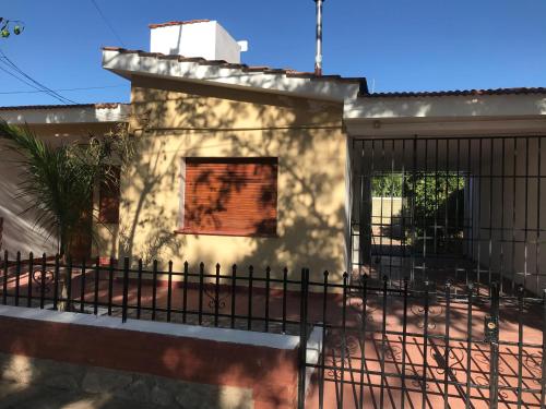 a house with a fence in front of it at El Bosque 1 in San Marcos Sierras