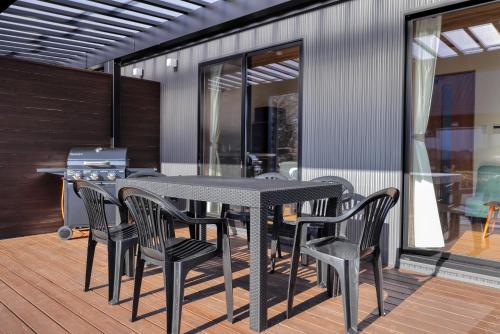 a black table and chairs on a deck at Villas Fuji Sengen ヴィラス富士浅間 in Fujiyoshida