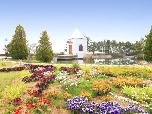 a garden of flowers in front of a white building at Matsushima Ichinobo in Matsushima