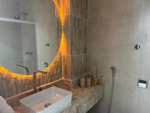 a bathroom with a sink and a shower at Studio Completo com Vista no Catete in Rio de Janeiro
