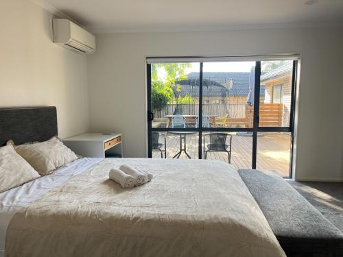 a bedroom with a bed with a towel on it at Family Retreat with Playground Views in East Tamaki in Auckland