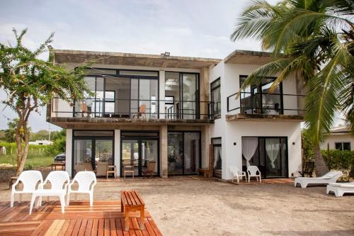 a large house with a deck and chairs at Taipan Casa de Playa in El Puertón