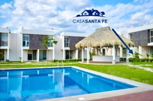 a resort with a swimming pool in front of a building at CASASANTA Fe cercalberca Wifi in Alpuyeca