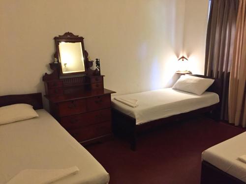 Postel nebo postele na pokoji v ubytování Galle Rest Home