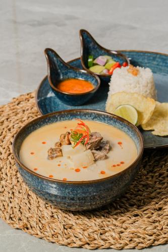a bowl of soup and a plate of food at Howard Johnson By Wyndham Tangerang in Tangerang