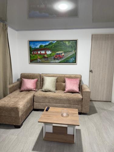 a living room with a couch and a coffee table at Beautiful New Apartment in Calarcá