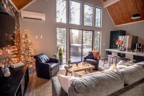 a living room with a couch and a table at Aspen Chalet Hot Tub, Fire Pit, Games,1-Acre in Durango