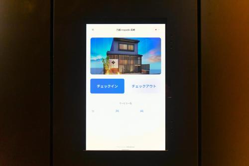 a phone screen with a picture of a house at 乃宿-noyado-長崎 in Nagasaki