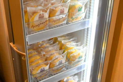 an open refrigerator filled with lots of food at 乃宿-noyado-長崎 in Nagasaki
