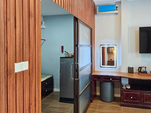 a kitchen with a stainless steel refrigerator in a room at The Son Resort in Ban Wang Phong