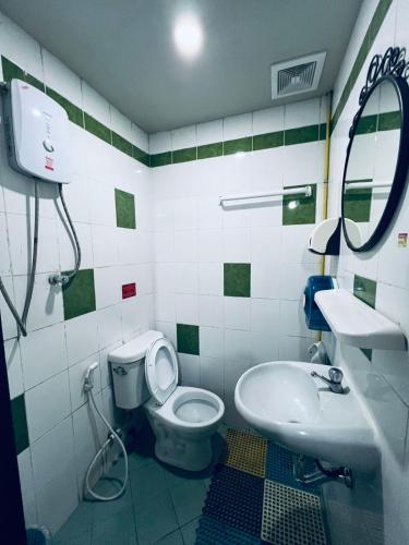 a bathroom with a toilet and a sink at Vientiane Star Hotel B in Vientiane