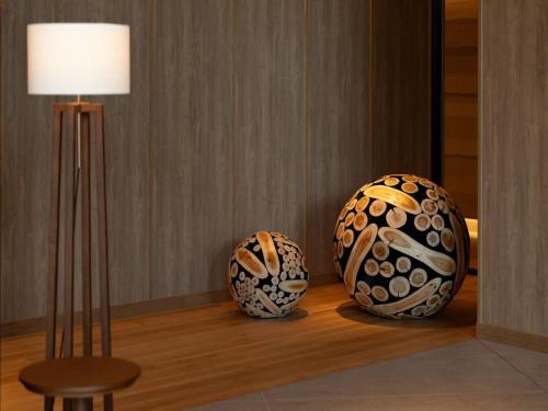 two vases sitting on a table next to a lamp at GREENITY IWATA in Iwata