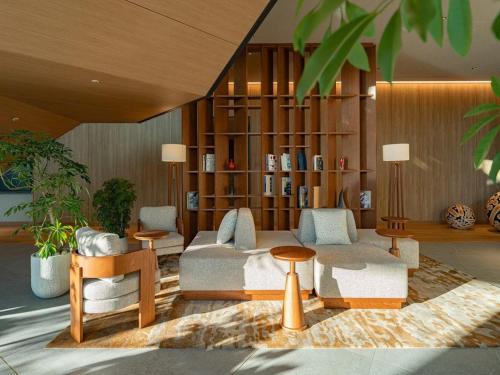 a living room with a couch and a book shelf at GREENITY IWATA in Iwata